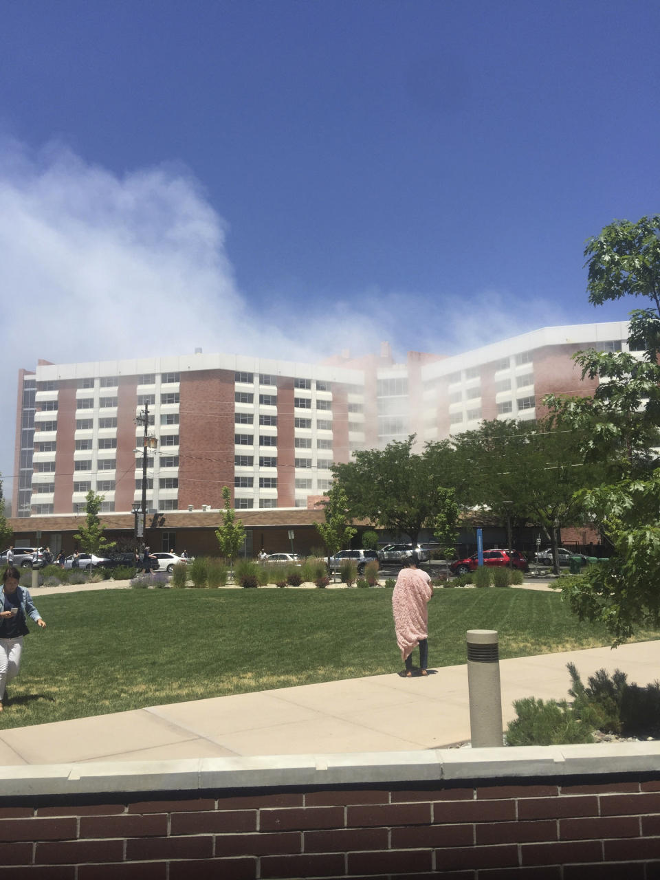 Plumes of smoke from an explosion inside a residence hall at the University of Nevada, Reno in Reno, Nev., is visible on Friday, July 5, 2019. Police referred to the incident as a "utilities accident." There were no immediate reports of injuries. (Raymond Floyd via The AP)