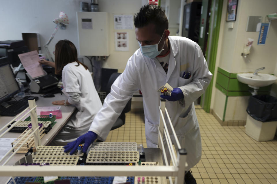 Health lab technician prepares samples to process analysis at the Hospital of Argenteuil, north of Paris, Friday Sept. 25, 2020. France's health agency announced Thursday evening that the country has had 52 new deaths and has detected over 16,000 new cases of coronavirus in 24 hours. (AP Photo/Francois Mori)