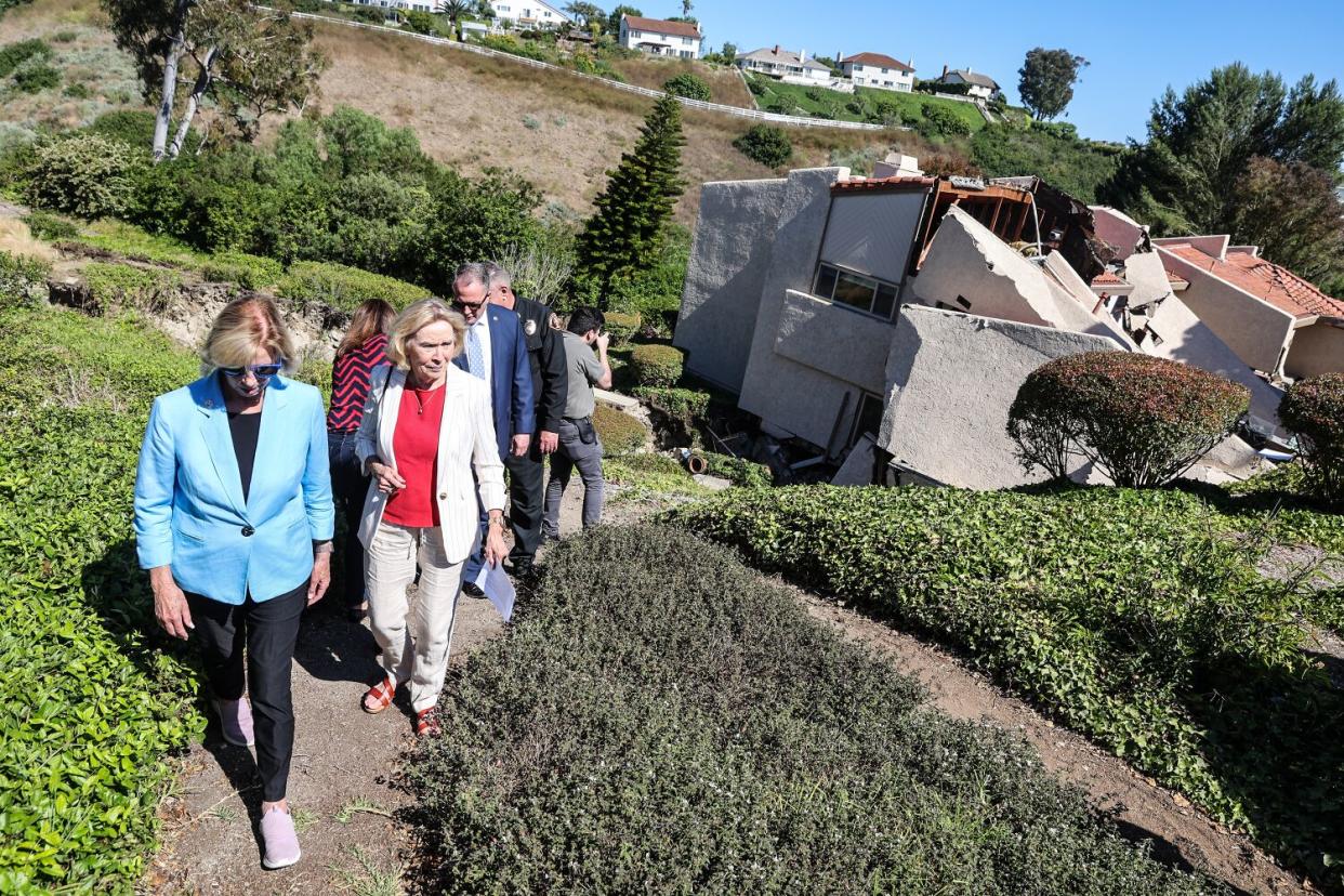 LA County Supervisor Janice Hahn, left, and Rolling Hills Estates Mayor Britt Huff tour site of collapsed homes