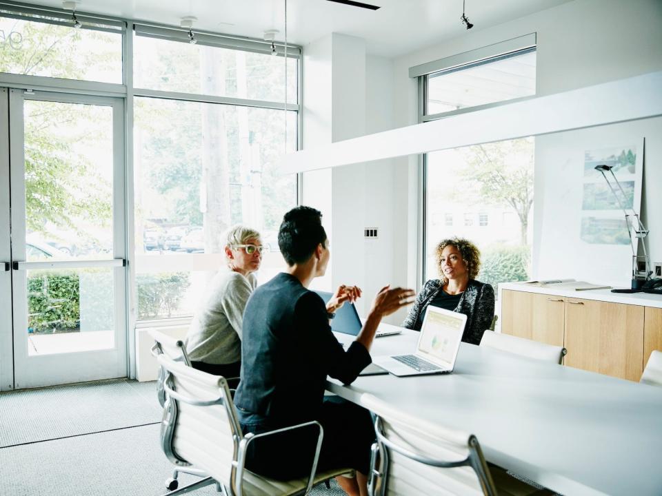 People sitting at a table and talking in an office