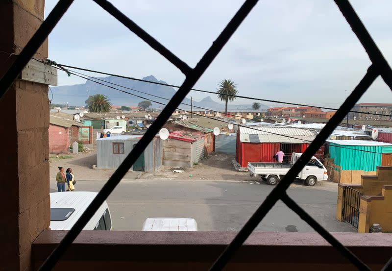 Shacks are seen through the doorway of domestic worker Alphonia Zali's two roomed apartment in Langa township near Cape Town