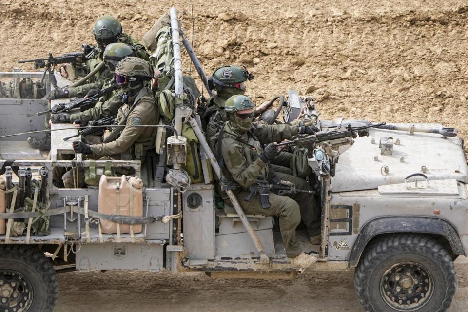 Soldiers in southern Israel drive toward the Gaza Strip on Tuesday