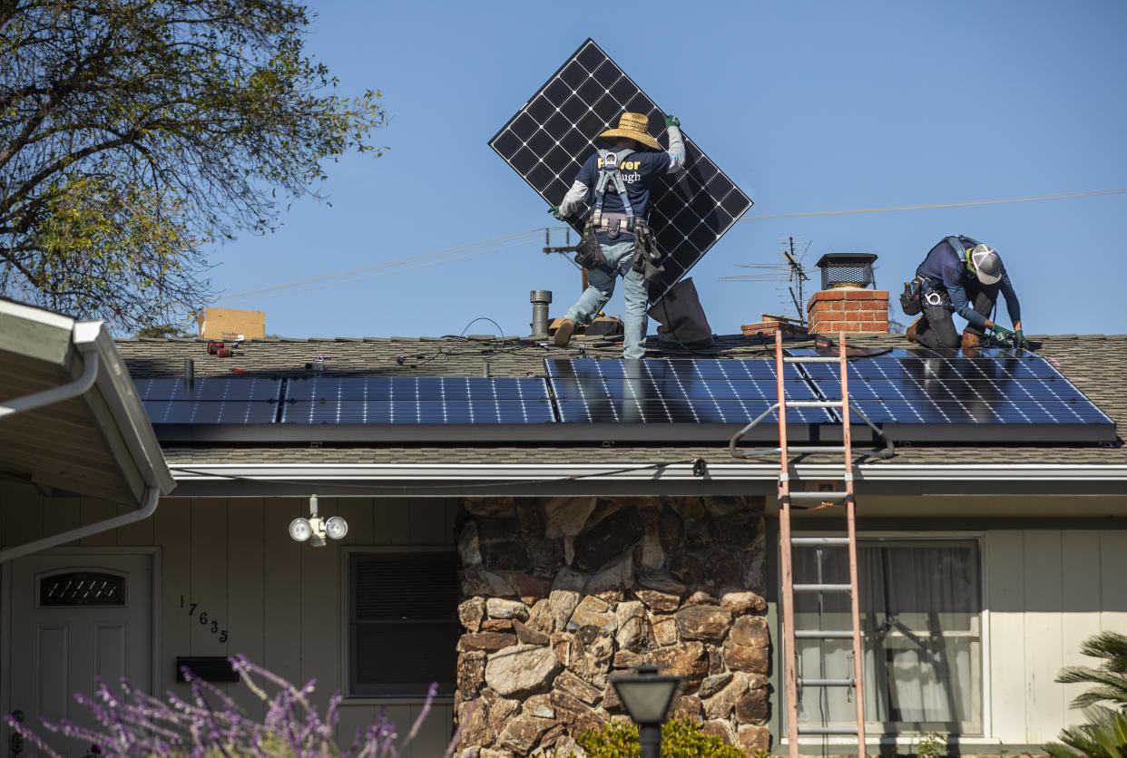 Workers install solar panels on a California home last year. (Photo: Mel Melcon via Getty Images)