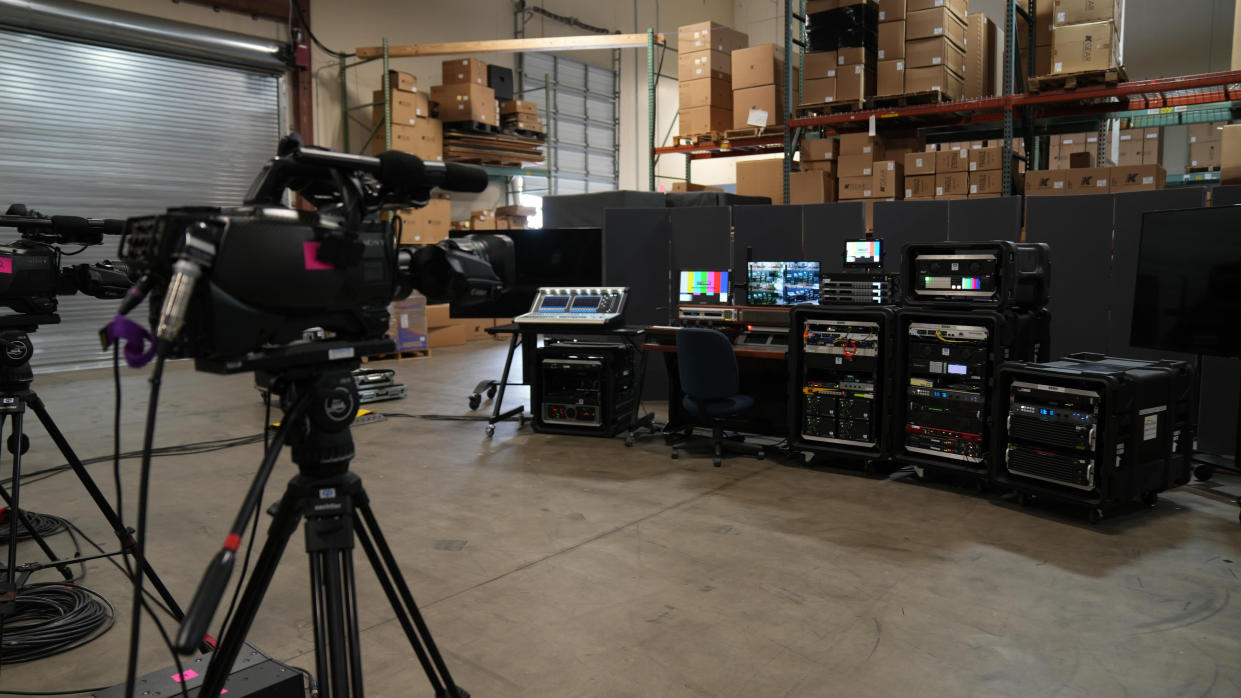  A camera focused on a production set and mixing board. 