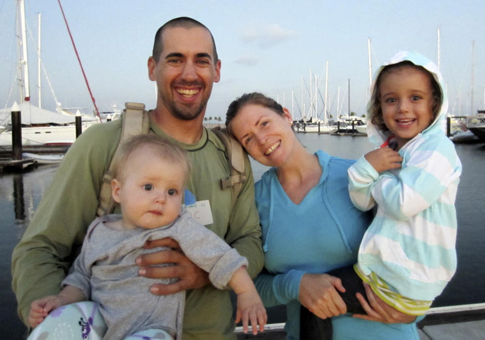 FILE - This undated file image provided by Sariah English shows Eric and Charlotte Kaufman with their daughters, Lyra, 1, and Cora, 3. None of the three federal agencies that helped rescue the ill 1-year-old and her family from their broken down sailboat about 900 miles off Mexico's Pacific coast plan to seek reimbursement for the cost of the operation. Officials from the Navy, Coast Guard and California Air National Guard said Tuesday, April 8, 2014, they don't charge for search-and-rescue missions. "We don't want people in trouble at sea to hesitate to call for help for fear they'll be charged for assistance," said Lt. Anna Dixon of the 11th Coast Guard District, which oversaw the operation but did not send vessels or aircraft to the stranded sailboat. She said that helping at sea is a time-honored tradition and a requirement of international maritime convention. The Navy warship that picked up the family on Sunday is expected to reach San Diego on Wednesday. (AP Photo/Sariah English. File)