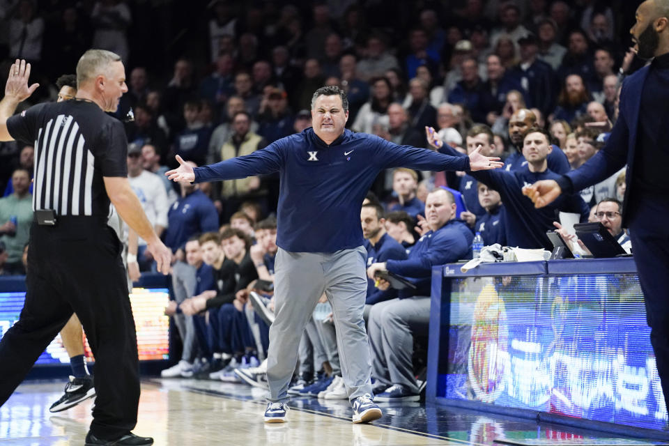 Xavier head coach Sean Miller reacts after Villanova head coach Kyle Neptune, right, crossed into his bench area during the second half of an NCAA college basketball game, Tuesday, Feb. 21, 2023, in Cincinnati. Neptune was assessed a technical foul for leaving his bench area. (AP Photo/Joshua A. Bickel)