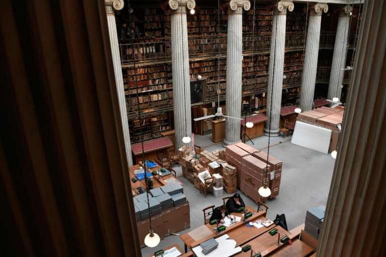 Specialised staff place books and other items kept at the National Library of Greece in wheeled, shock-absorbing boxes for their historic trip to the other end of Athens