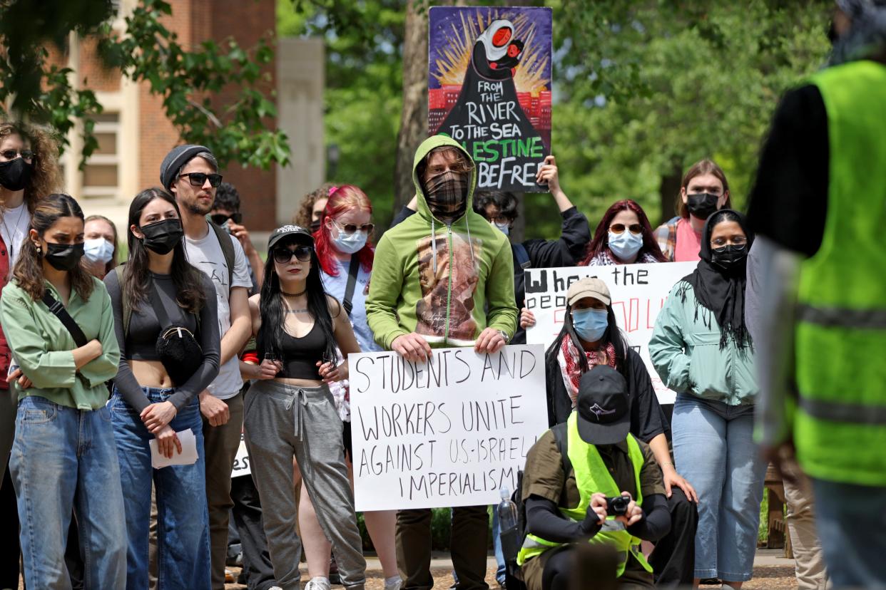 People hold signs in support of Palestine during a May Day rally hosted by the University of Oklahoma's Student Coalition for Palestinian Liberation and Student Socialist League on Wednesday on the OU campus in Norman.