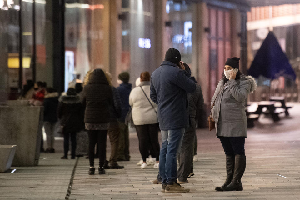 Shoppers queue outside Next in Leicester during the Boxing Day sales. Boxing Day spending is expected to fall by more than a quarter compared with a year ago, after extensive new Covid-19 restrictions forced non-essential retailers to close. (Photo by Joe Giddens/PA Images via Getty Images)