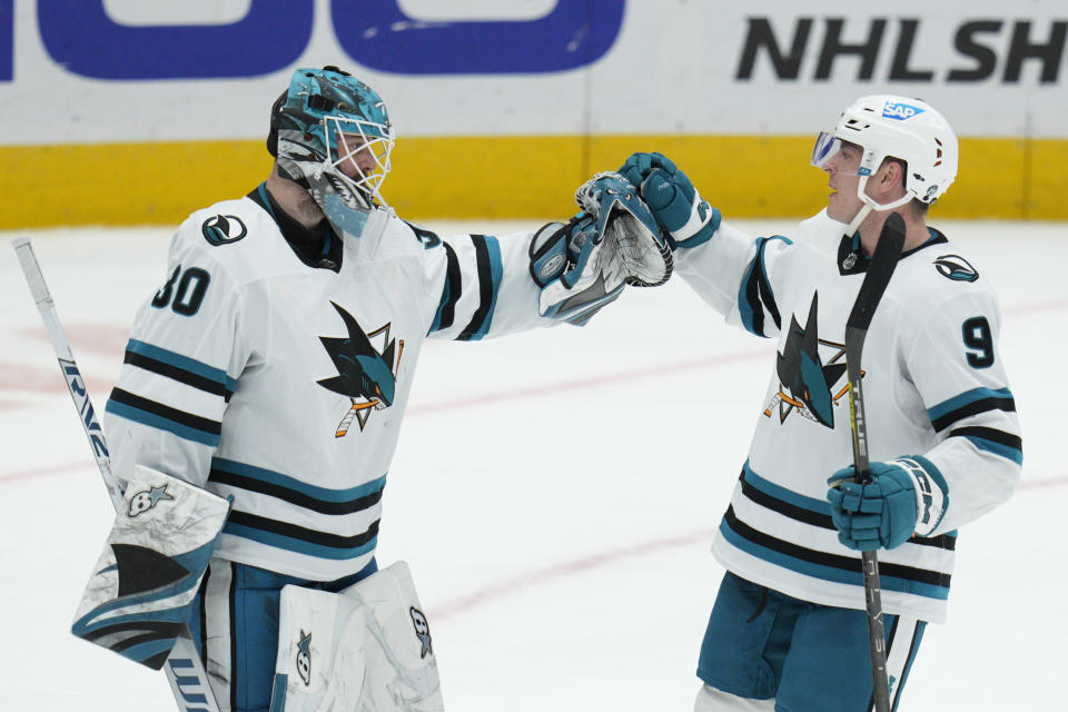 San Jose Sharks goaltender Aaron Dell (30) celebrates with defenseman Jacob MacDonald (9) after an NHL hockey game against the Washington Capitals, Sunday, Feb. 12, 2023, in Washington. (AP Photo/Jess Rapfogel)