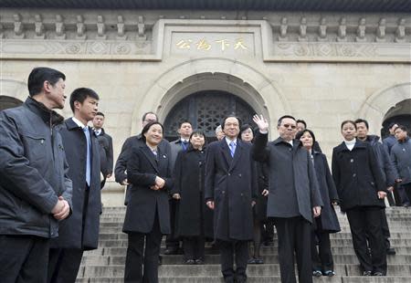 Taiwan's Mainland Affairs Minister Wang Yu-chi (front R) waves as he leaves after visiting the Sun Yat-sen mausoleum in Nanjing, Jiangsu province, February 12, 2014. REUTERS/Stringer