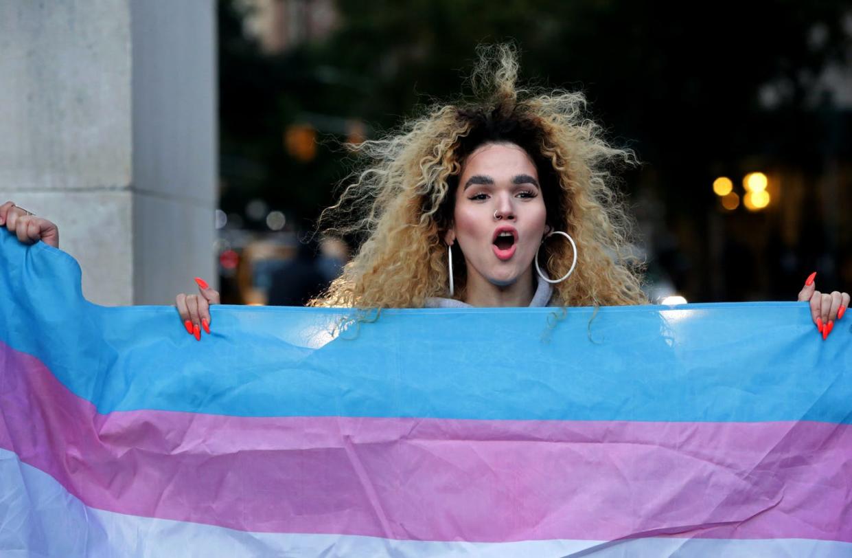 <span class="caption">The pandemic has made it difficult for trans people to support one another in person, or celebrate important physical changes with friends. </span> <span class="attribution"><a class="link " href="https://www.gettyimages.com/detail/news-photo/morgin-dupont-a-woman-of-trans-experience-holds-up-the-flag-news-photo/1052725806" rel="nofollow noopener" target="_blank" data-ylk="slk:Yana Paskova/Getty Images;elm:context_link;itc:0;sec:content-canvas">Yana Paskova/Getty Images</a></span>