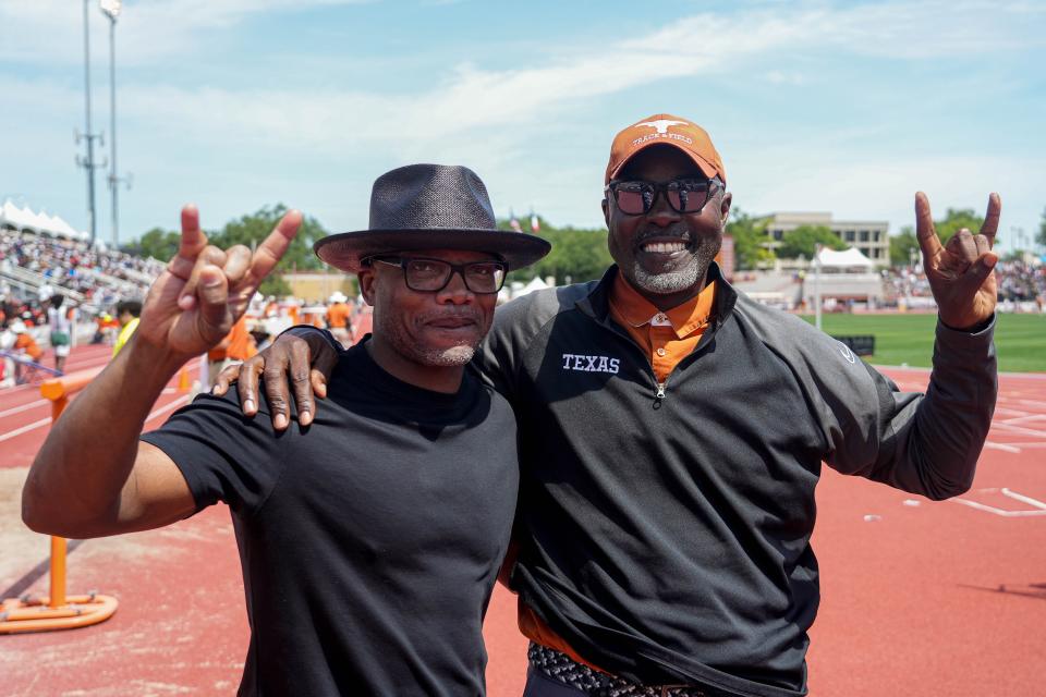 Former Texas football and track star Eric Metcalf, left, visits with UT track coach Edrick Floréal at the Texas Relays on Saturday at Mike A. Myers Stadium. Before he went on to a 12-year playing career in the NFL, Metcalf was one of the first Longhorns to star in two sports.