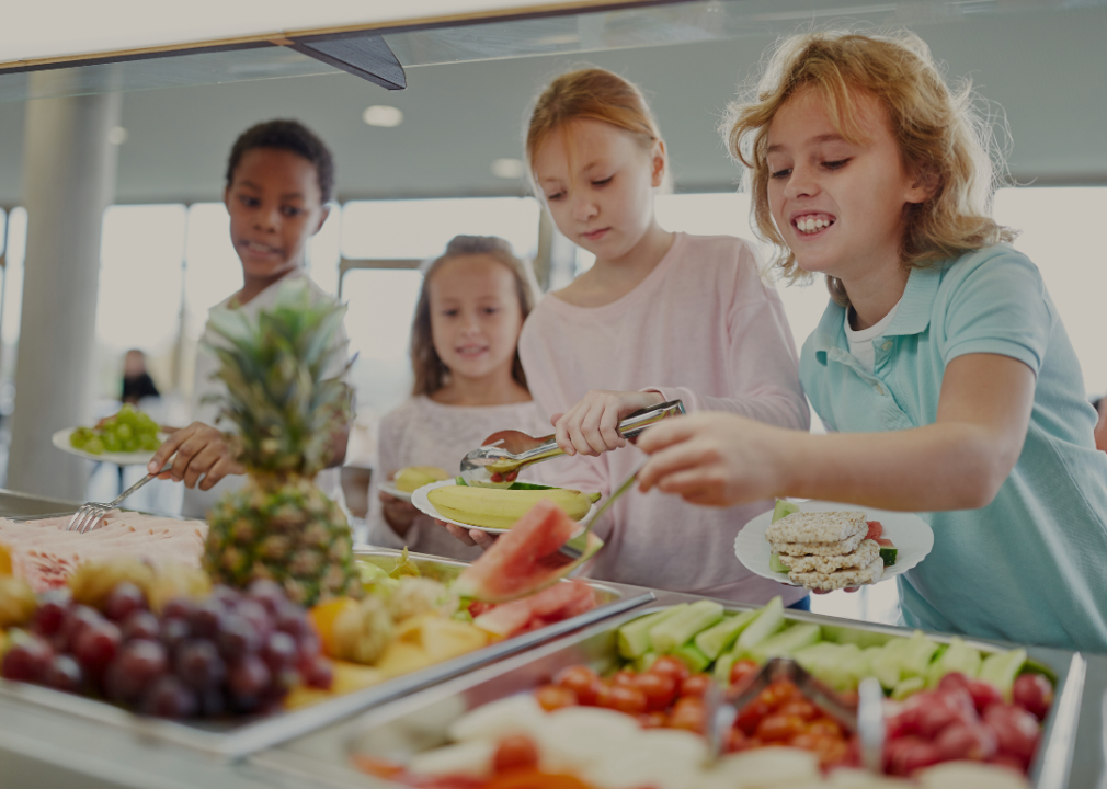 Children at the buffet in a canteen choosing their lunch. 