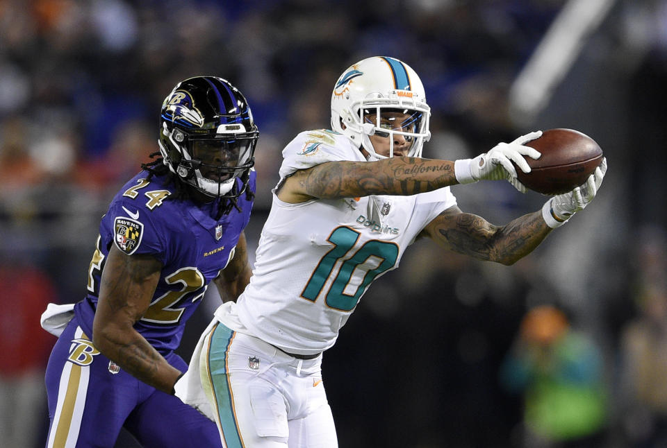 FILE - In this Oct. 26, 2017, file photo, Miami Dolphins wide receiver Kenny Stills (10) catches a pass in front of Baltimore Ravens cornerback Brandon Carr in the second half of an NFL football game in Baltimore. The Houston Texans continued a busy day of trades by addressing a glaring need to upgrade their offensive line by acquiring left tackle Laremy Tunsil from the Dolphins in a deal which also netted them receiver Kenny Stills, a source familiar with the deal tells The Associated Press. (AP Photo/Nick Wass, File)