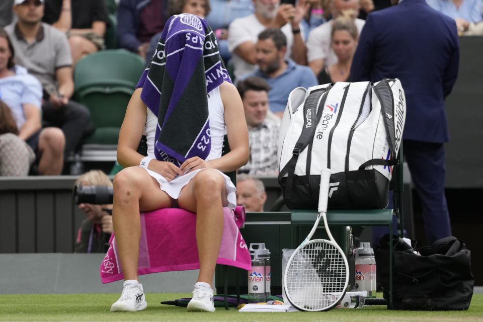 Poland's Iga Swiatek sits in her chair during a change of ends break as she plays Switzerland's Belinda Bencic in a women's singles match on day seven of the Wimbledon tennis championships in London, Sunday, July 9, 2023. (AP Photo/Kirsty Wigglesworth)