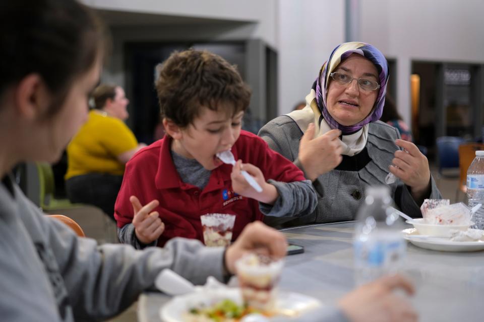 Kevser Gokalp, at right, speaks during a 2023 Dialogue Institute-Oklahoma/Raindrop Turkish House Ramadan Iftar dinner at the Homeless Alliance in Oklahoma City.