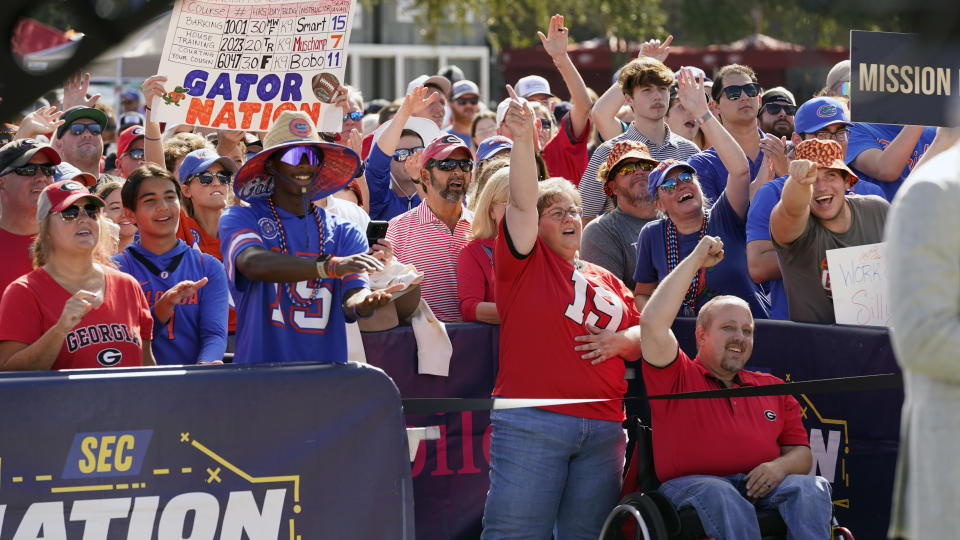 Fans cheer during a pregame TV show before an NCAA college football game between Florida and Georgia, Saturday, Oct. 28, 2023, in Jacksonville, Fla. (AP Photo/John Raoux)