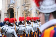 VATICAN CITY, VATICAN - DECEMBER 25: Swiss Guards perform ceremonial duties during the Christmas Day message 'urbi et orbi' blessing (to the city and to the world) delivered by Pope Benedict XVI from the central balcony of St Peter's Basilica on December 25, 2012 in Vatican City, Vatican. (Photo by Franco Origlia/Getty Images)