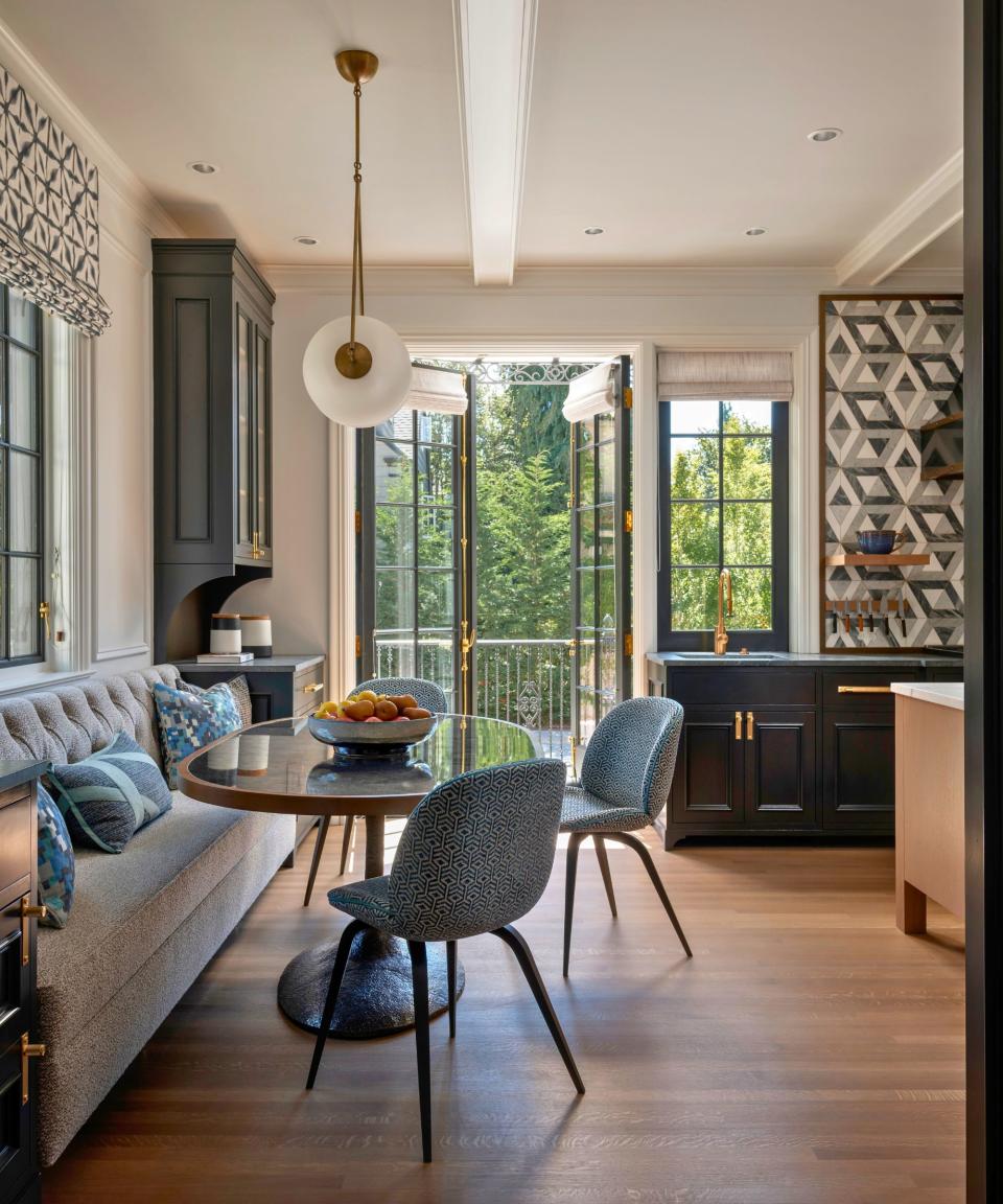 kitchen dining nook with banquette seat and round table wooden floor