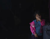 A child stands alone at a school that was used as a refuge from Hurricane Orlene in Escuinapa, Mexico, Monday, Oct. 3, 2022. Hurricane Orlene made landfall on Mexico's Pacific coast near the tourist town of Mazatlan on Monday before quickly weakening over western Mexico. (AP Photo/Fernando Llano)