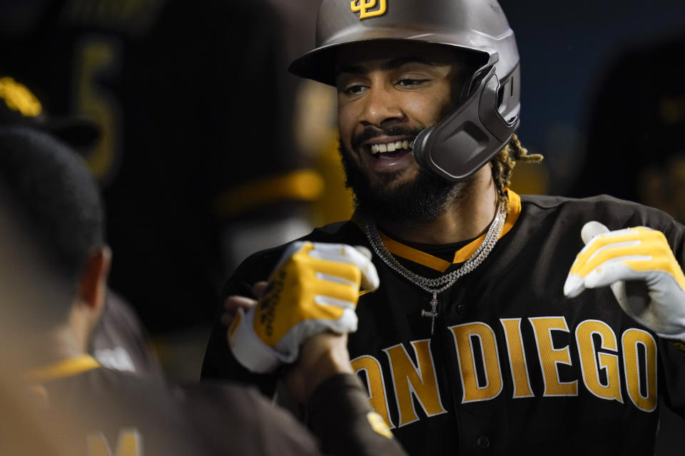 FILE - San Diego Padres' Fernando Tatis Jr. celebrates in the dugout after hitting a home run during the fifth inning of a baseball game against the Los Angeles Dodgers, Sept. 30, 2021, in Los Angeles. Tatis Jr.'s surgically repaired left wrist hasn't progressed to the point where the electrifying All-Star shortstop can start swinging a bat, general manager A.J. Preller said Tuesday June 14, 2022. (AP Photo/Ashley Landis, File)