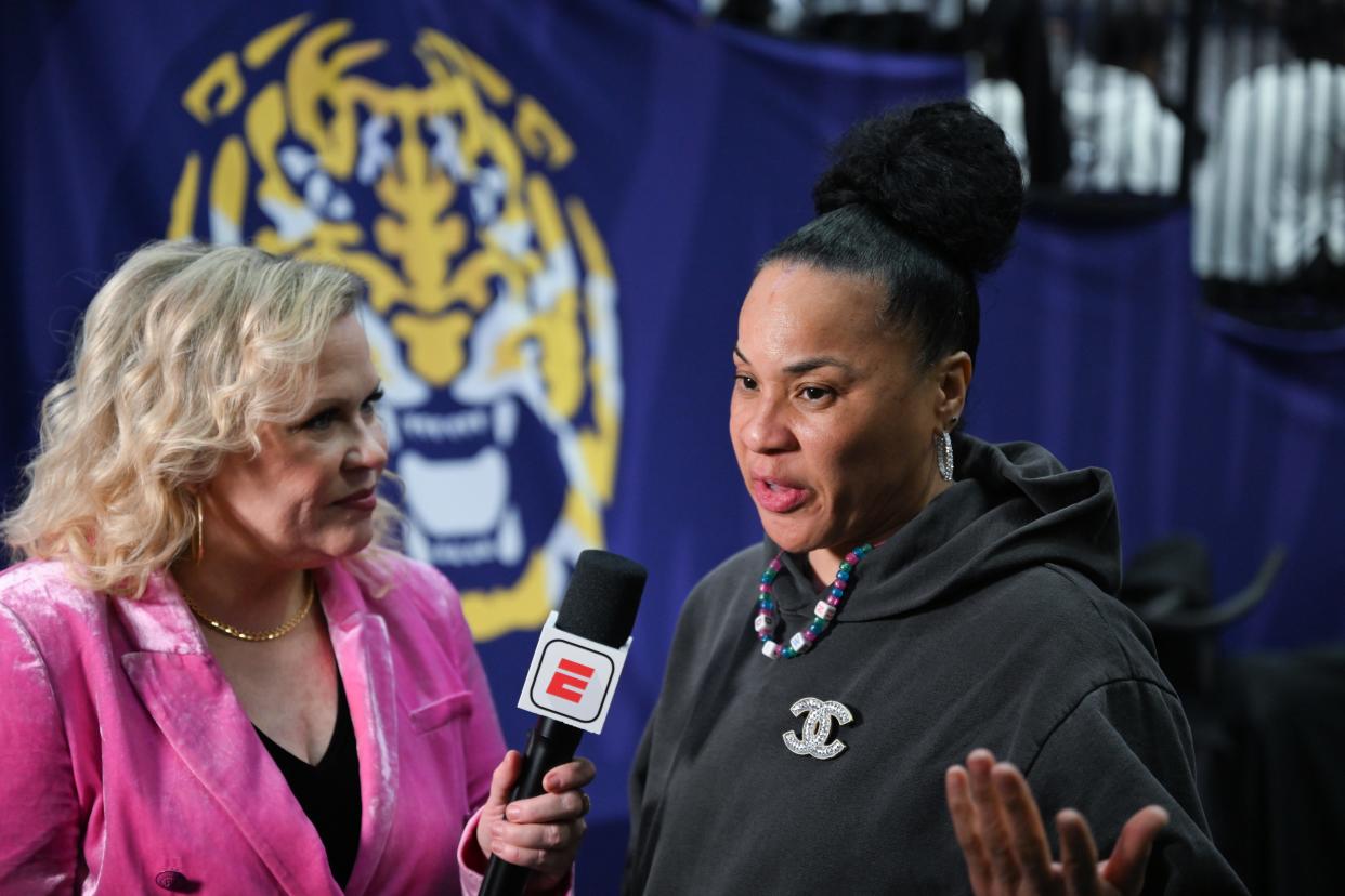 ESPN reporter and play-by-play commentator Holly Rowe talks to South Carolina coach Dawn Staley before a game against LSU on Jan. 25 in Baton Rouge, La.
