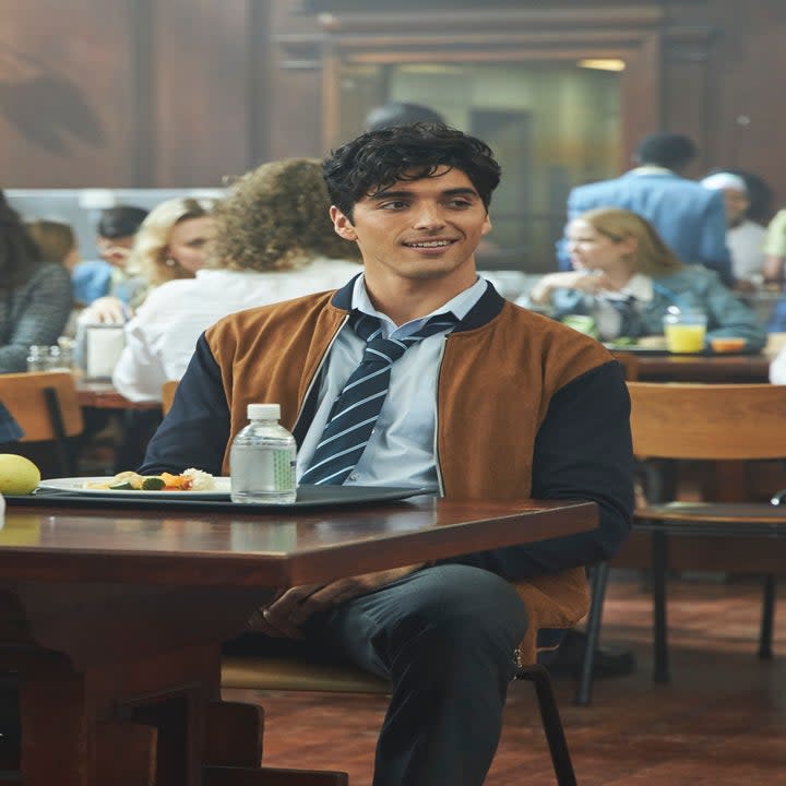 Taylor's character sitting in a school cafeteria