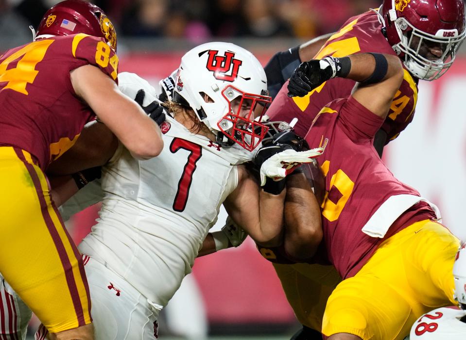 Oct 9, 2021; Los Angeles, California, USA; Utah Utes defensive end Van Fillinger (7) stops USC Trojans running back Vavae Malepeai (6) at the line of scrimmage during the fourth quarter at United Airlines Field at Los Angeles Memorial Coliseum. Mandatory Credit: Robert Hanashiro-USA TODAY Sports