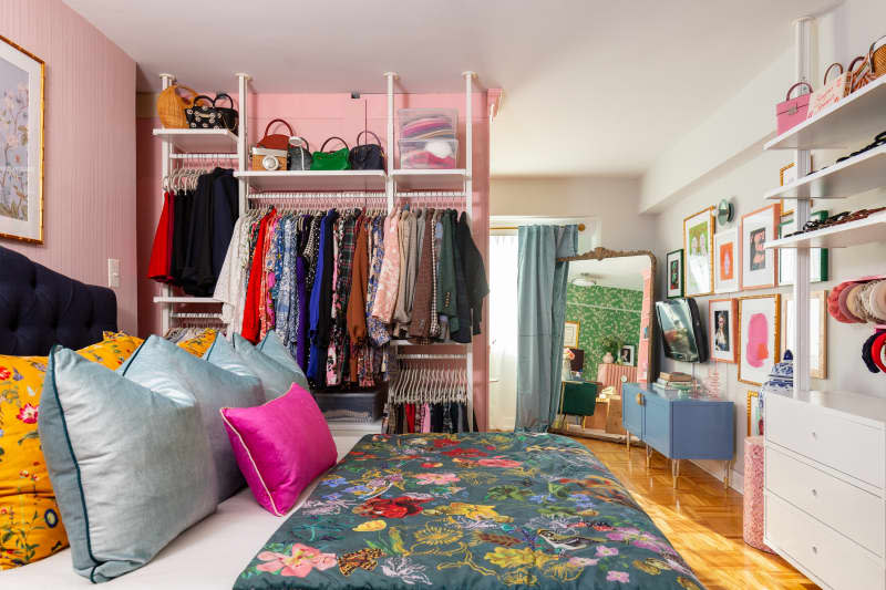 A bedroom with an open-face closet.