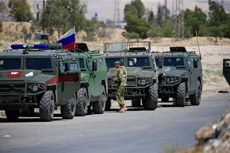 Russian military vehicles are seen in eastern Ghouta near Douma, in Damascus, Syria April 23, 2018. REUTERS/Ali Hashisho