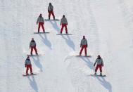 <p>Workers fix the slope after Joel Gisler of Switzerland crashed. REUTERS/Mike Blake </p>