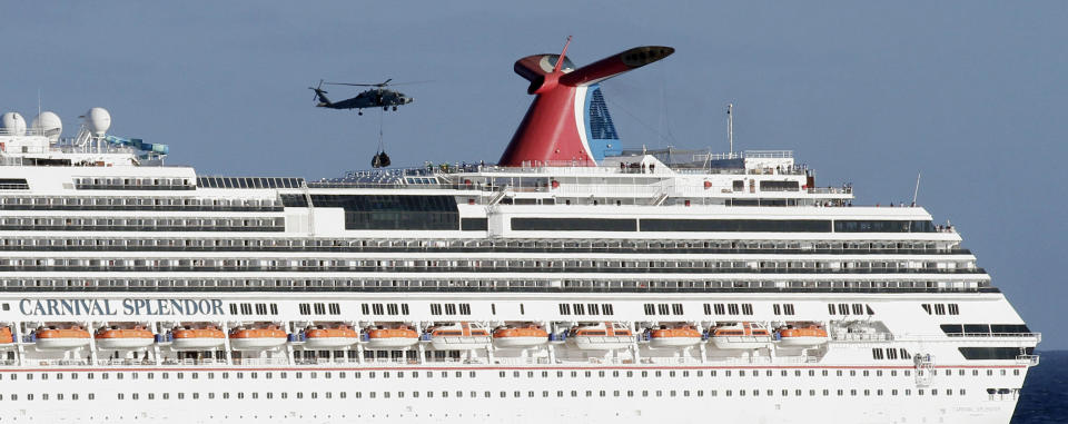 FILE - In this Nov. 9, 2010, file photo, a Navy Seahawk helicopter prepares to drop supplies onto the Carnival Splendor cruise ship during relief efforts in waters off Mexico's Baja Peninsula, seen from the USS Ronald Reagan aircraft carrier. Cruise operators, like airline pilots, may be relying too heavily on electronics to navigate massive ships, losing the knowledge and ability needed to operate a vessel in the case of a power failure, an expert sea pilot told a federal agency on Wednesday. (AP Photo/Gregory Bull, File)