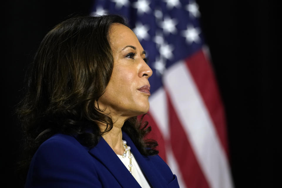 Sen. Kamala Harris, D-Calif., listens as Democratic presidential candidate former Vice President Joe Biden introduces her as his running mate at Alexis Dupont High School in Wilmington, Del., Wednesday, Aug. 12, 2020. (AP Photo/Carolyn Kaster)