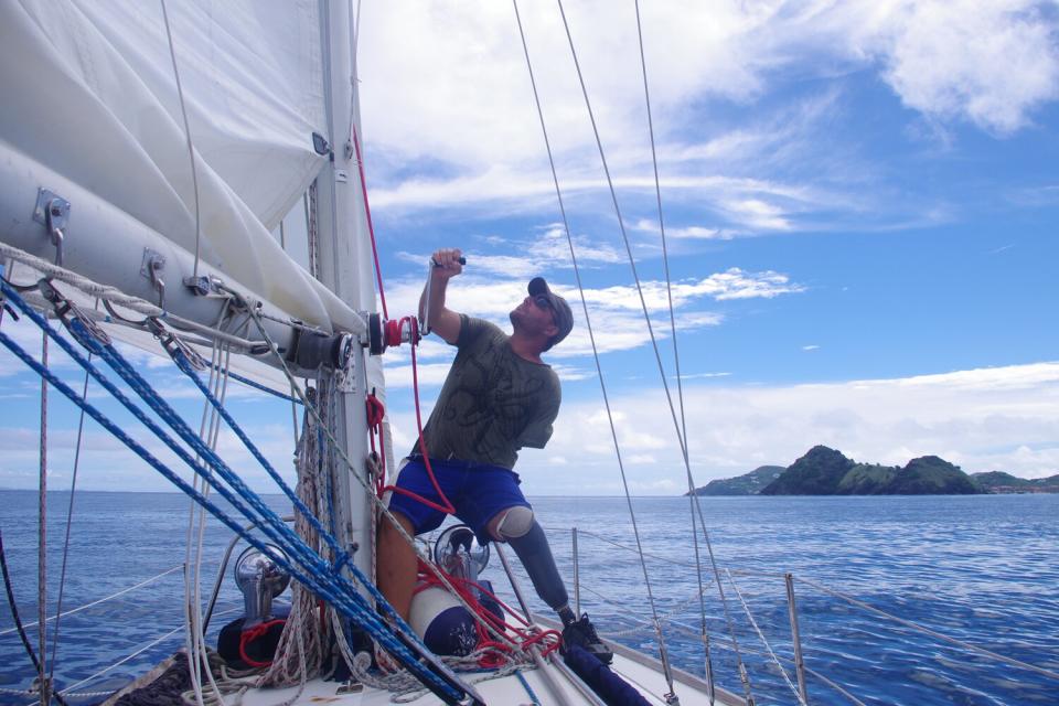 Dustin Reynolds and his sailboat Rudis, achieved the GUINNESS WORLD RECORDS® title for the first solo voyage around the world by a double amputee (arm and leg).