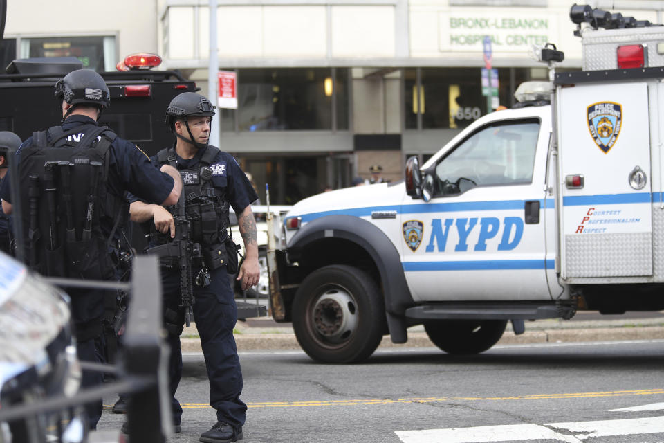 <p>A heavily armed police officer stands outside Bronx Lebanon Hospital after a gunman opened fire and then took his own life there on Friday, June 30, 2017. The gunman, identified as Dr. Henry Bello who used to work at the hospital, returned with a rifle hidden under his white lab coat, law enforcement officials said. (AP Photo/Mary Altaffer) </p>