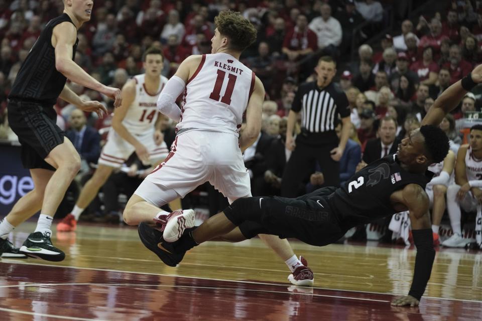 Wisconsin's Max Klesmit is called for a charge on Michigan State's Tyson Walker during the second half of an NCAA college basketball game Tuesday, Jan. 10, 2023, in Madison, Wis. (AP Photo/Morry Gash)