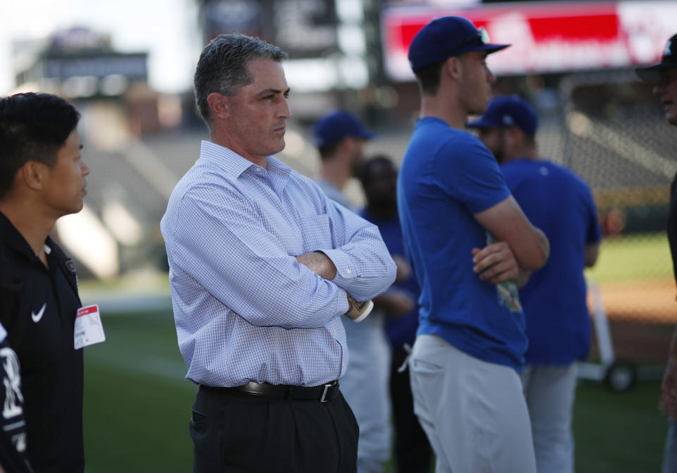 FILE - Colorado Rockies general manager Jeff Bridich watches the team warm up before a baseball game against the Los Angeles Dodgers, in this file photograph taken Friday, Sept. 7, 2018, in Denver. Bridich and Rockies owner Dick Monfort held a news conference Tuesday, Feb. 2, 2021, to discuss the trade of the team's star third baseman, Nolan Arenado, to the St. Louis Cardinals. (AP Photo/David Zalubowski, File)