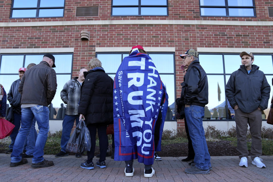Supporters wait to enter a former President Donald Trump commit to caucus rally, Wednesday, Dec. 13, 2023, in Coralville, Iowa. (AP Photo/Charlie Neibergall)