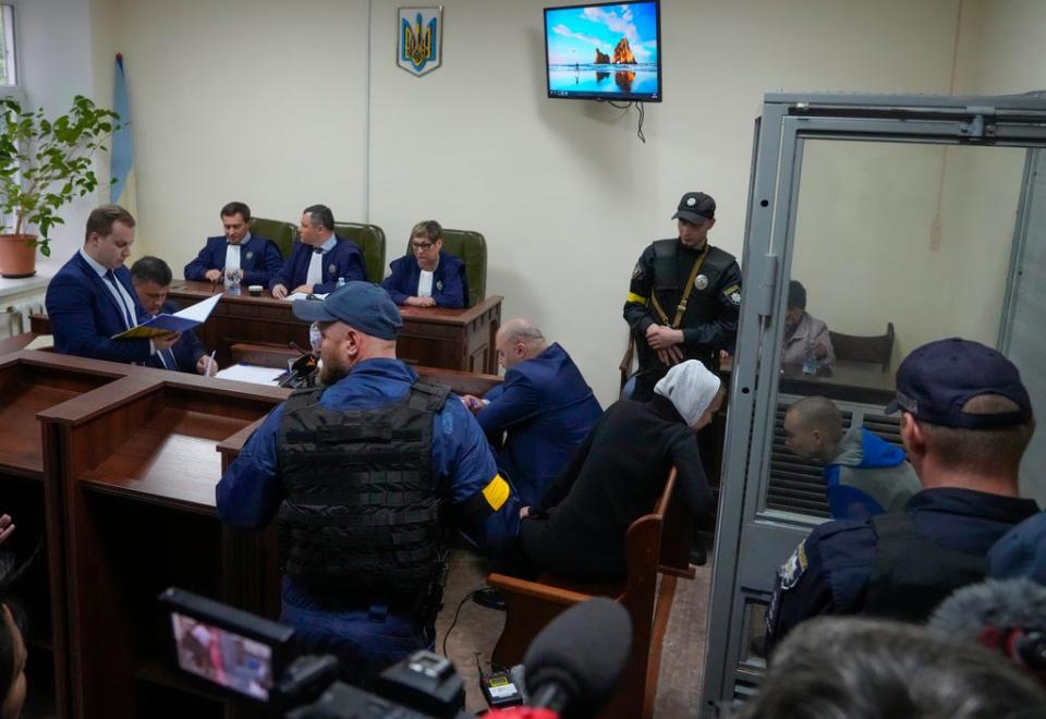 Shishimarin behind glass speaking to his translator at the court in Kyiv (Efrem Lukatsky/AP)