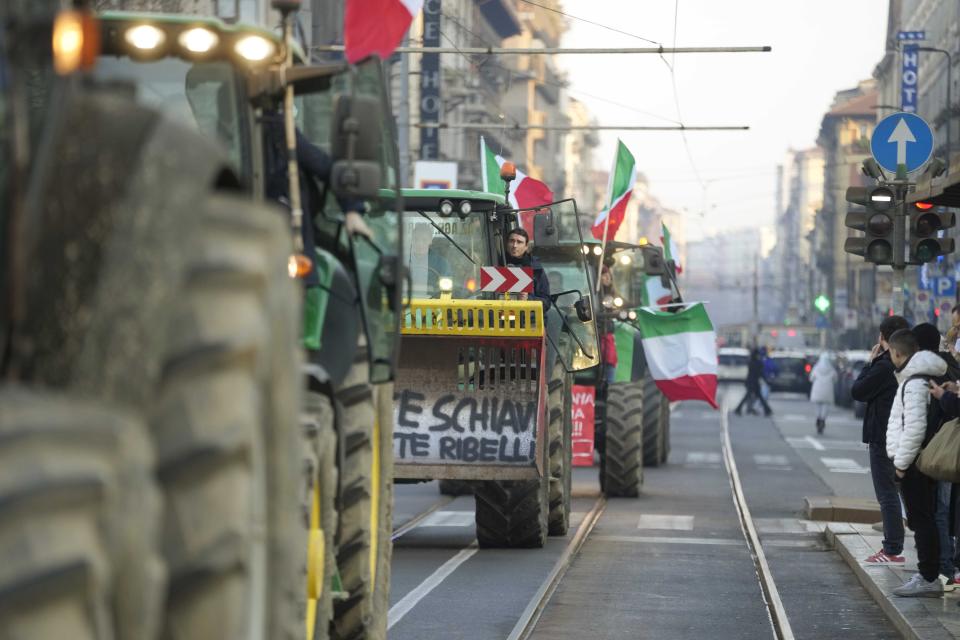 Farmers run their tractors in Milan, Italy, Thursday, Feb. 1, 2024. Farmers have been protesting in various parts of Italy and Europe against EU agriculture policies. (AP Photo/Luca Bruno)