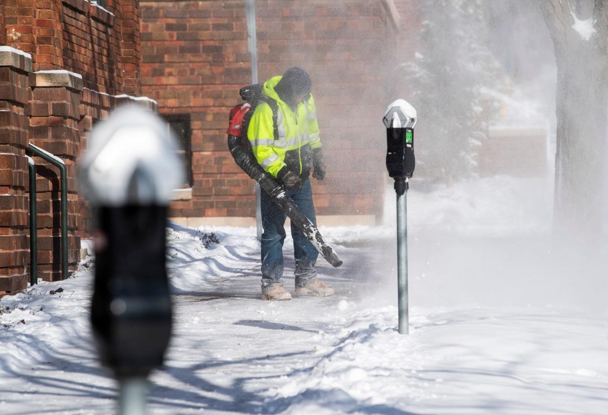 City of Bloomington employee Alejandro Adriano cleans off sidewalks along Morton Street on Friday, Jan. 19, 2024.