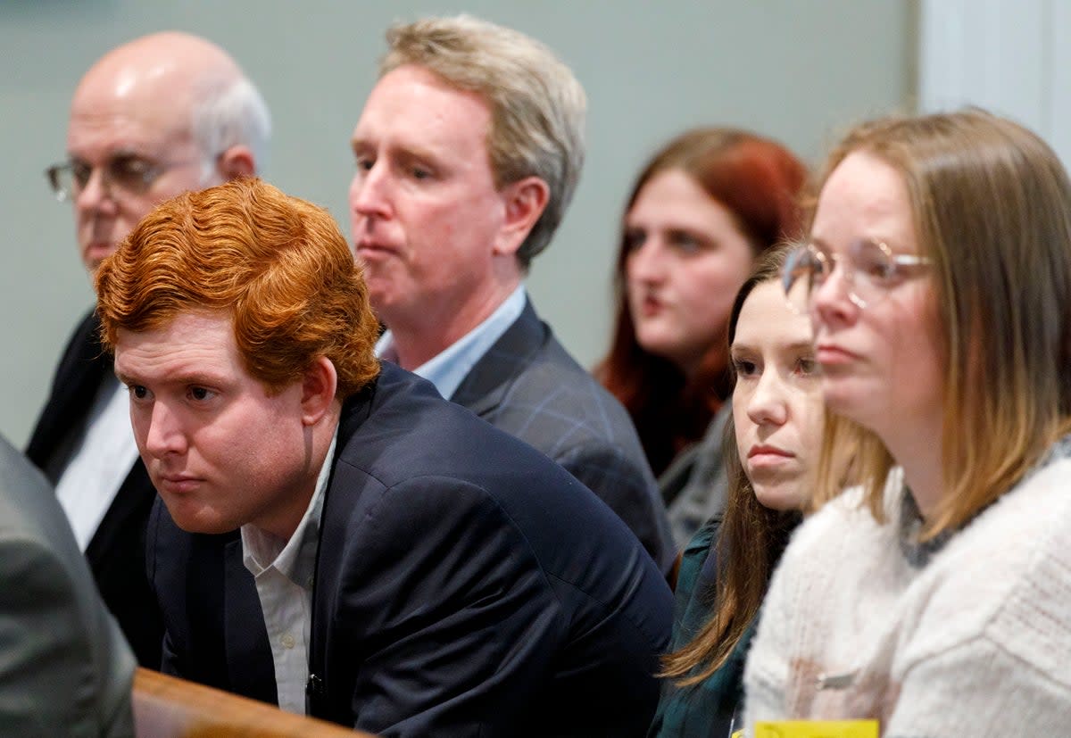 Members of the Murdaugh family, including his son Buster Murdaugh in centre, at the murder trial (AP)