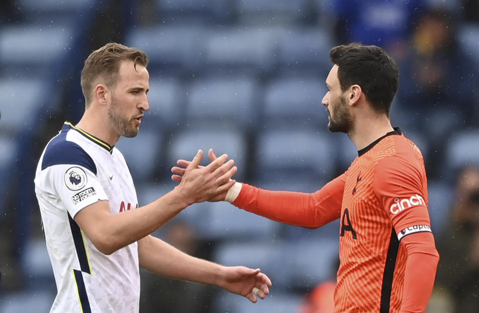 Tottenham's Harry Kane, left, shakes hands with Tottenham's goalkeeper Hugo Lloris at the end of the English Premier League soccer match between Leicester City and Tottenham Hotspur at the King Power Stadium, in Leicester, England, Sunday, May 23, 2021. (Shaun Botterill/Pool via AP)