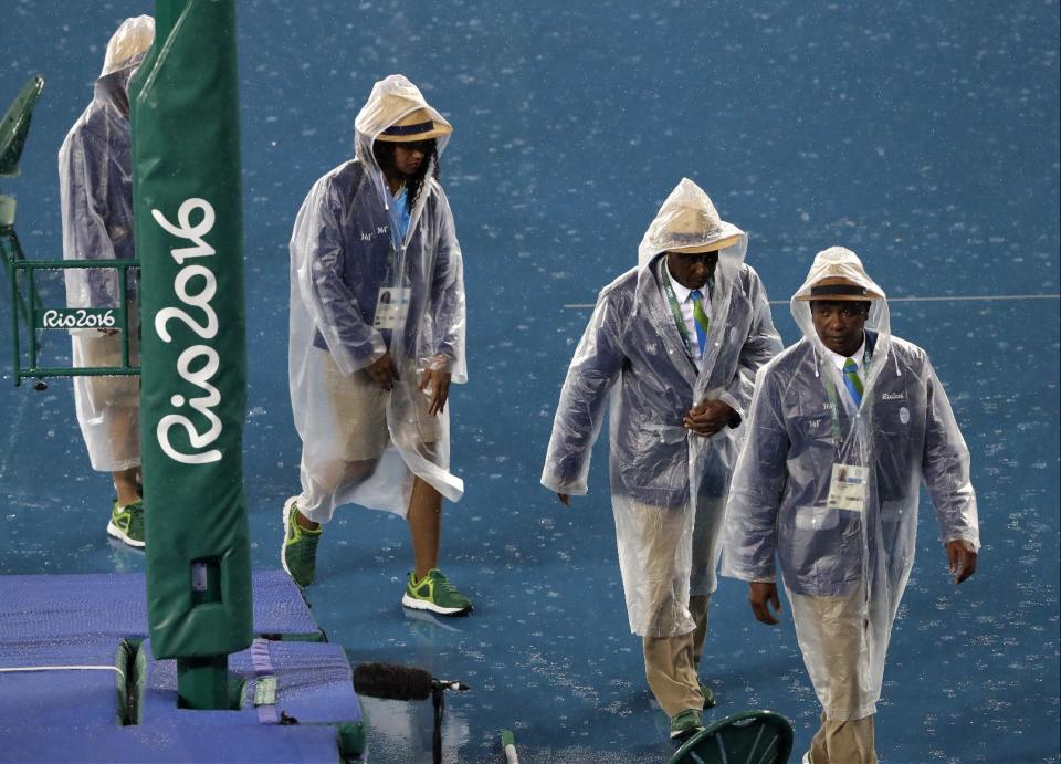 Judges in the rain in Rio. (AP)