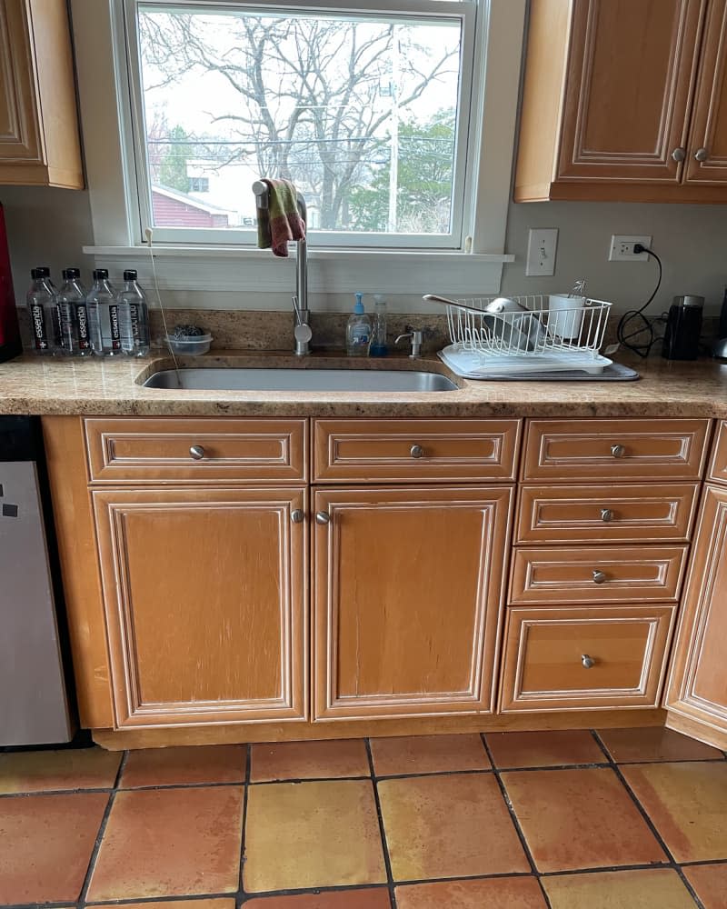 Wooden cabinets in kitchen before renovation.