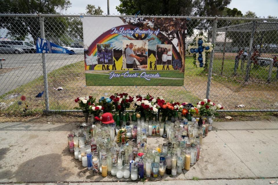 In the background a memorial sign for Jose is a photo of the Wilmington Recreation Center. Its mural shows the silhouettes of children holding a shotgun and a pistol. It's a call for peace.