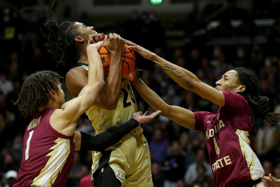 Florida State guard Jalen Warley (1) and Florida State guard Caleb Mills (4) fight Purdue guard Jaden Ivey (23) for the ball during the first half of an NCAA men's basketball game, Tuesday, Nov. 30, 2021 at Mackey Arena in West Lafayette.