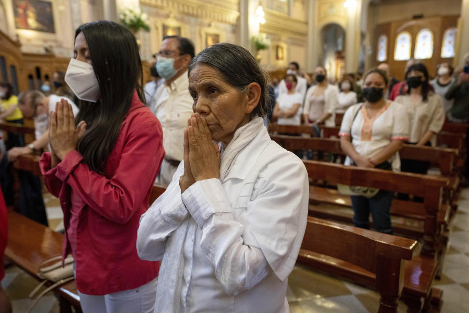 Women pray during a mass in memory of all priests and religious men and women who have been murdered in Mexico, in Mexico City, Sunday, July 10, 2022. In the wake of the murders of two Jesuit priests two weeks ago in Chihuahua, the Society of Jesus and other religious institutions called for a day of prayer and peace. (AP Photo/Moises Castillo)