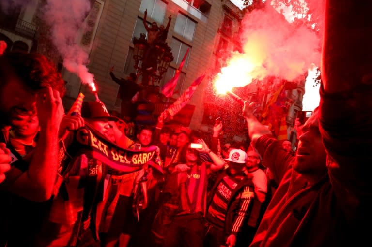 FC Barcelona's supporters celebrate with flares after their team's 24th La Liga title at the Canaletes fountain on Las Ramblas in Barcelona, on May 14, 2016